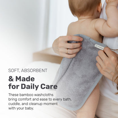 Parent drying a baby with a gray Lamb Babies washcloth