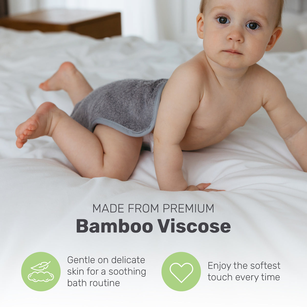 Baby lying on a gray Lamb Babies washcloth