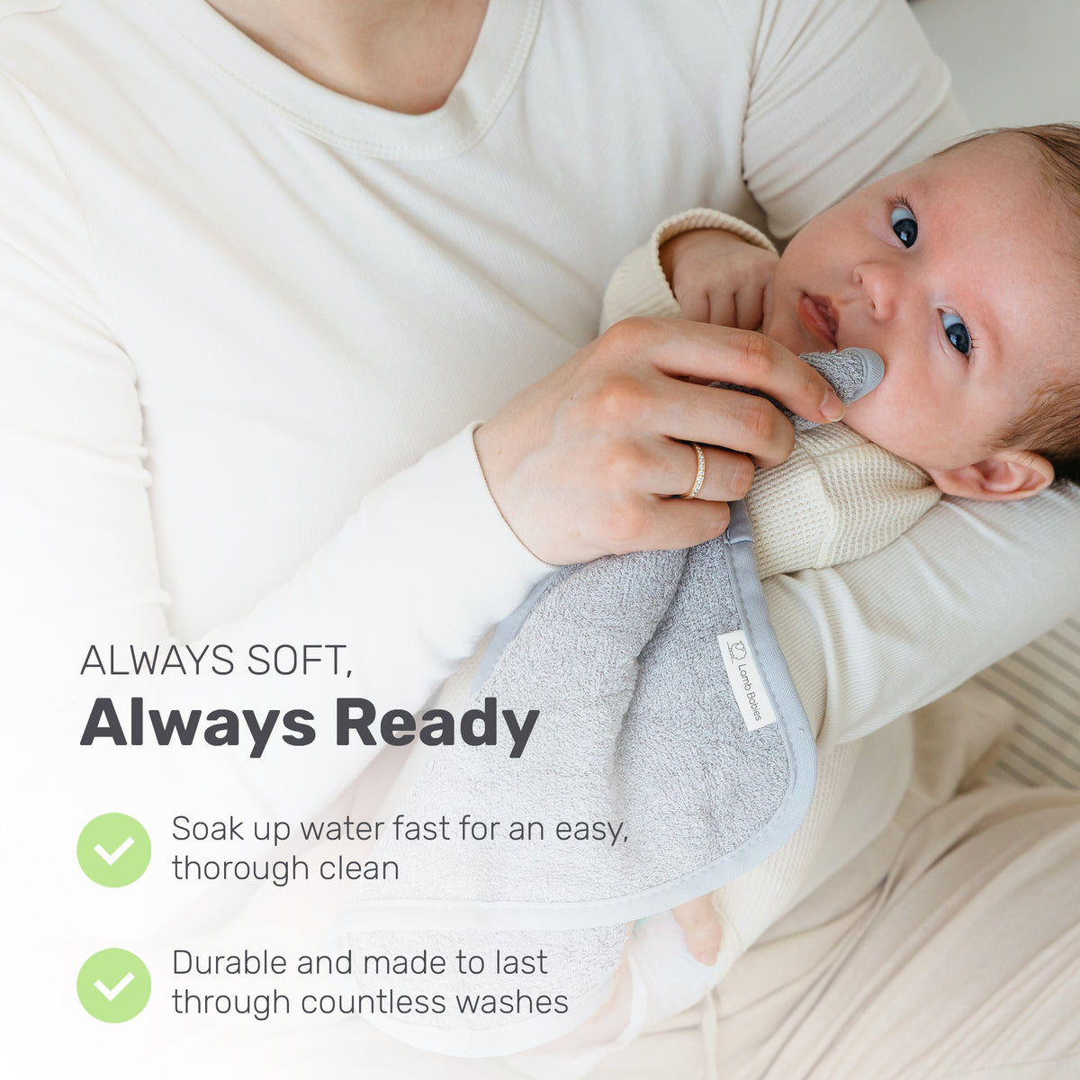 Parent holding a baby with a gray Lamb Babies washcloth
