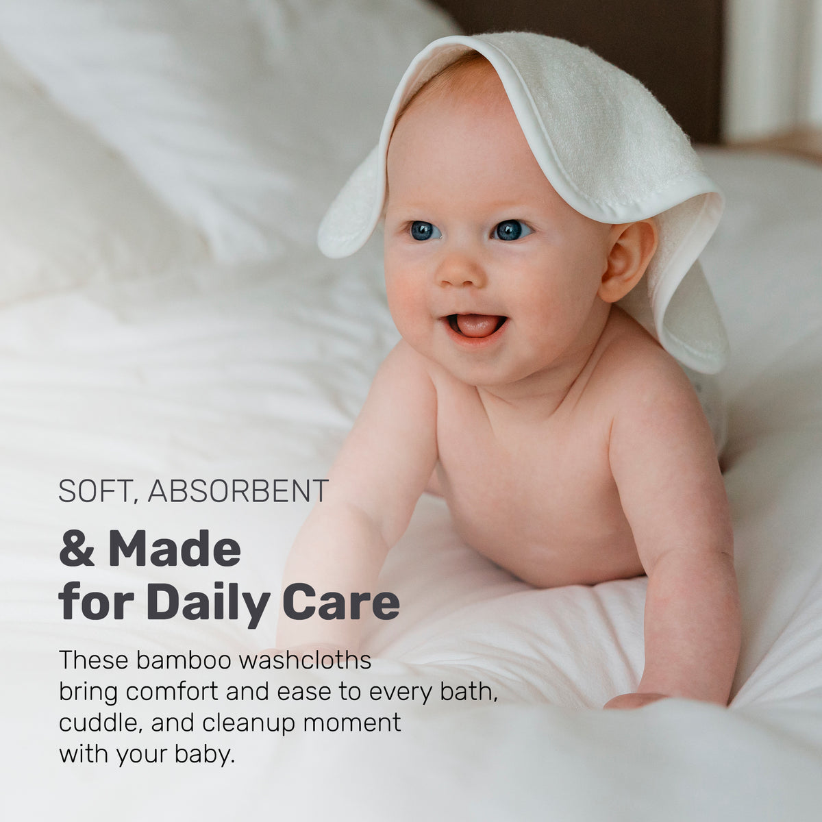 Smiling baby with a white Lamb Babies washcloth on their head