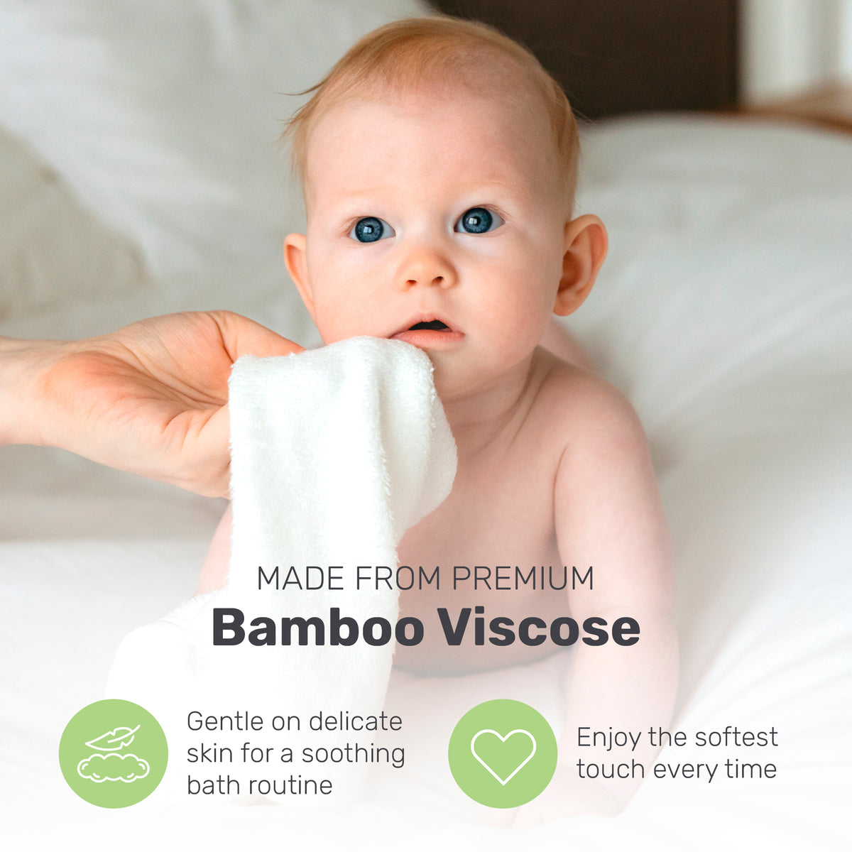 Baby holding a white Lamb Babies washcloth
