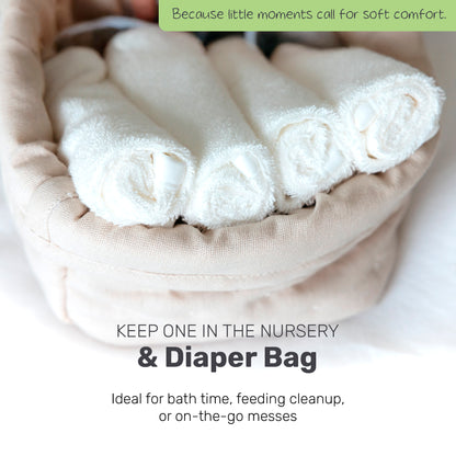 Rolled white Lamb Babies washcloths in a basket for the nursery or diaper bag
