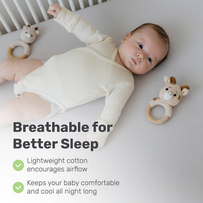 Baby resting on a Lamb Babies crib sheet