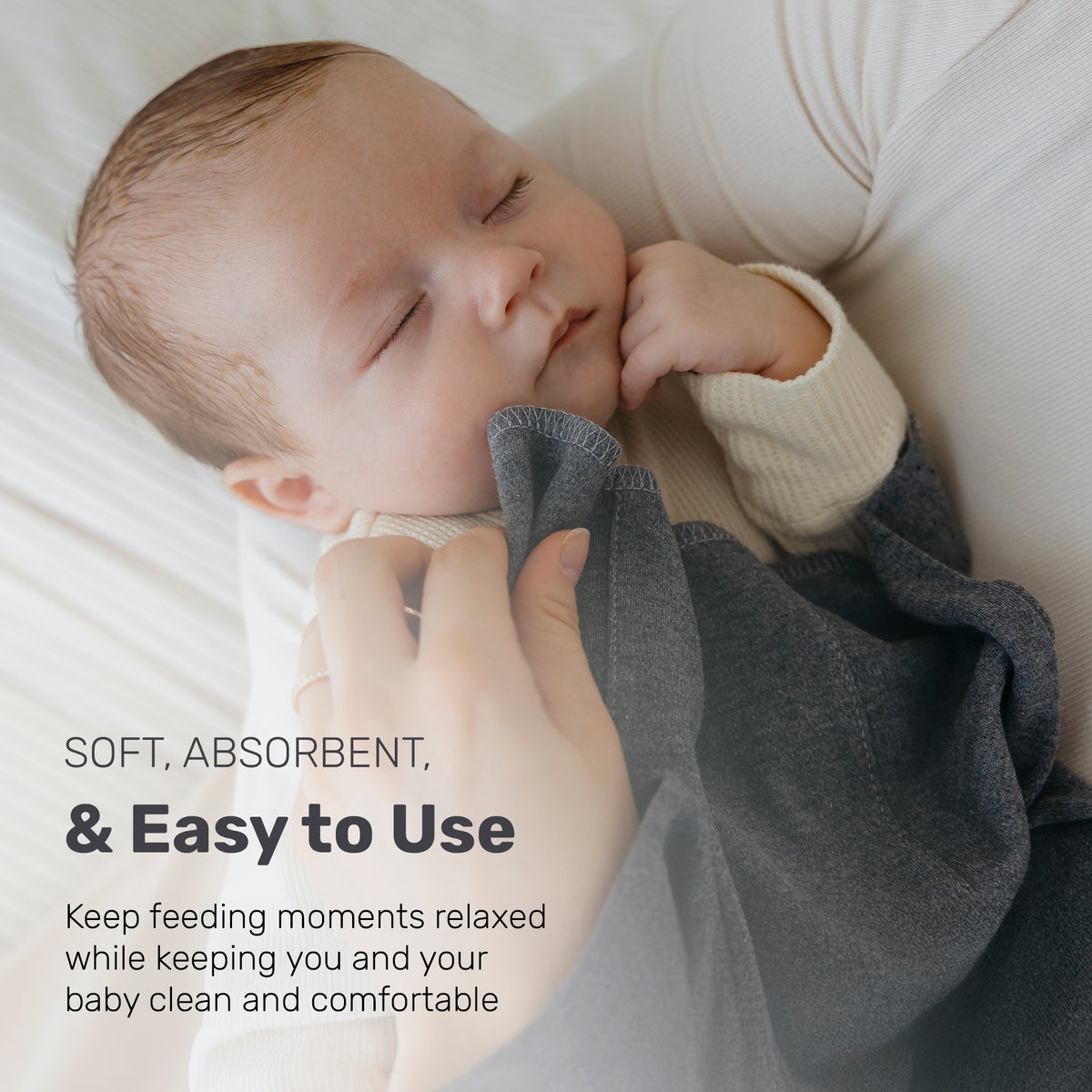 Baby sleeping next to a patterned Lamb Babies Snug Burp Cloth