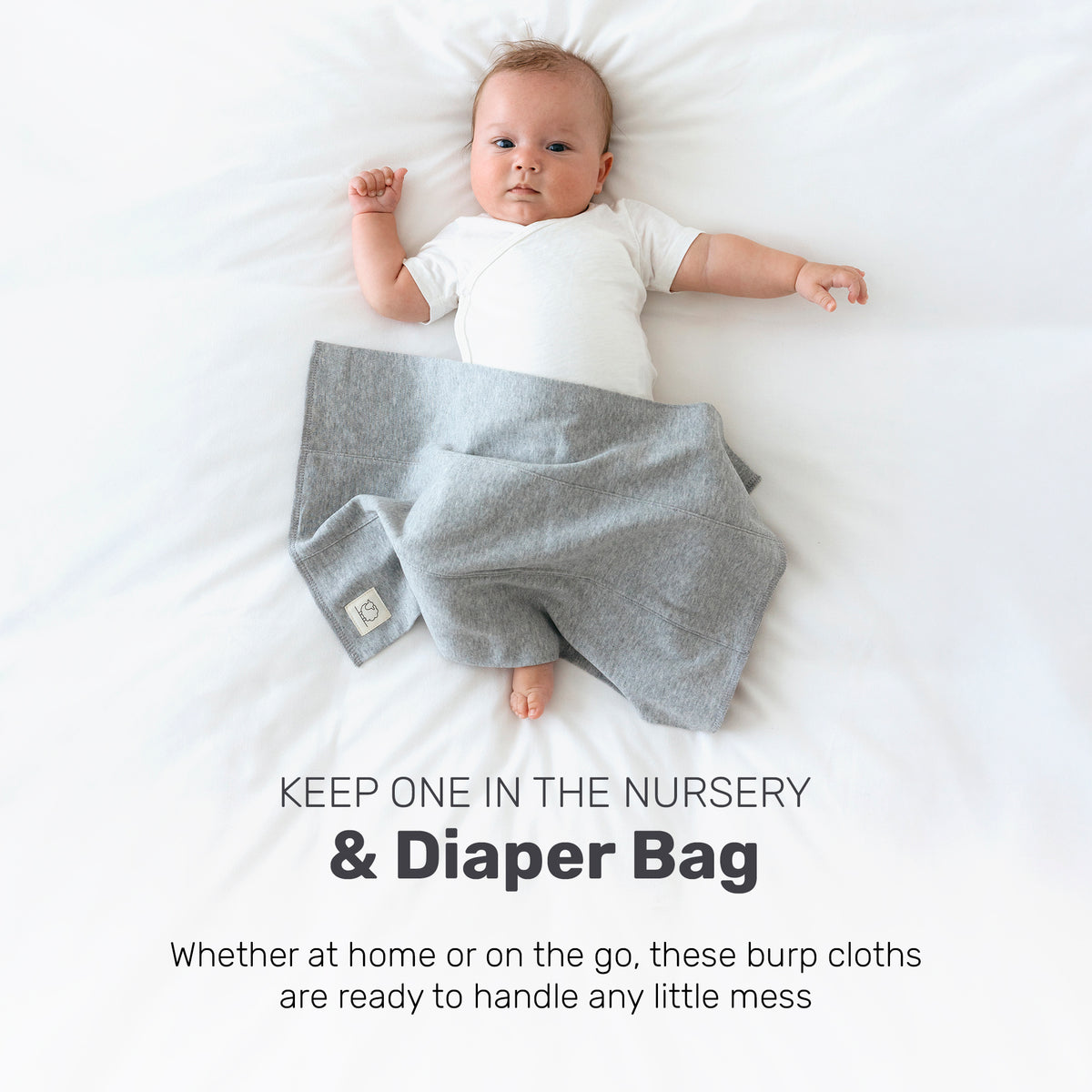 Baby with a patterned Lamb Babies Snug Burp Cloth, for the nursery or diaper bag