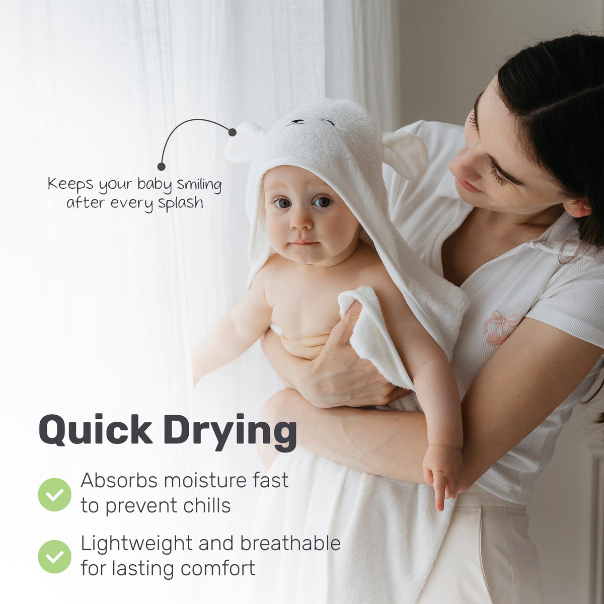 Parent drying a baby with a Lamb Babies hooded towel