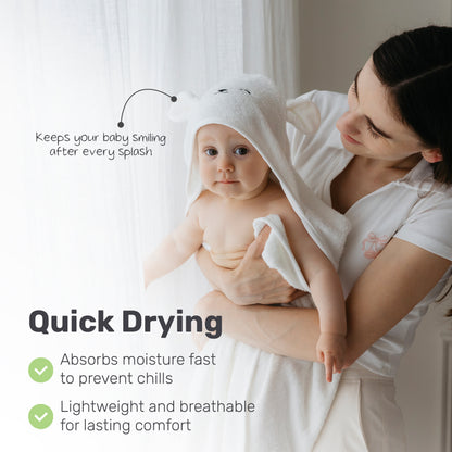 Parent drying a baby with a Lamb Babies hooded towel